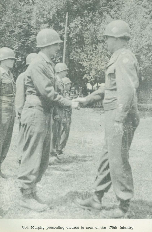 Col. Murphy presenting awards to men of the 179th Regiment